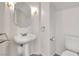 This bathroom features a pedestal sink, an octagon mirror, and classic fixtures at 9785 Gallo Dr, Las Vegas, NV 89147