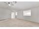 A carpeted bedroom features light walls, a ceiling fan, and a view to another room at 9785 Gallo Dr, Las Vegas, NV 89147