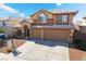Two-story home with a tile roof, two-car garage, and desert landscaping at 9785 Gallo Dr, Las Vegas, NV 89147