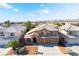 Charming two-story home boasts a well-maintained yard, arched entryway, two-car garage, and tile roof at 9785 Gallo Dr, Las Vegas, NV 89147