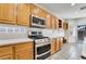 Kitchen featuring stainless steel appliances, wood cabinets, light countertops, and backyard access at 9785 Gallo Dr, Las Vegas, NV 89147