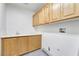 The laundry room features built in cabinets and a utility sink at 9785 Gallo Dr, Las Vegas, NV 89147