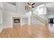 Bright and open living room featuring a fireplace, vaulted ceiling, staircase, and front door at 9785 Gallo Dr, Las Vegas, NV 89147