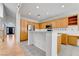 Open-concept living space with light colored wood floors, kitchen access, and large windows at 9785 Gallo Dr, Las Vegas, NV 89147