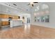 Spacious open-concept living space featuring wood floors, a kitchen, and large windows at 9785 Gallo Dr, Las Vegas, NV 89147