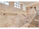 This custom shower is finished with travertine tile, glass block windows, and dual shower heads at 9785 Gallo Dr, Las Vegas, NV 89147