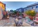 Inviting backyard patio featuring a stone fire pit, string lights, and comfortable seating areas at 10422 Prairie Mountain Ave, Las Vegas, NV 89166