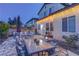 Relaxing backyard patio featuring outdoor dining, a fire pit, pavers, and comfortable seating at 10422 Prairie Mountain Ave, Las Vegas, NV 89166