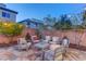 Charming backyard patio with decorative brick, stone pavers, comfortable seating, and mature trees at 10422 Prairie Mountain Ave, Las Vegas, NV 89166
