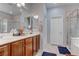 Spacious bathroom with double sinks, tile flooring, and a glass-enclosed shower at 10422 Prairie Mountain Ave, Las Vegas, NV 89166