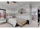 Cozy bedroom with striped walls, comfortable bed, and adjacent hallway view at 10422 Prairie Mountain Ave, Las Vegas, NV 89166