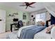 Comfortable bedroom with desk area, a ceiling fan, and lots of wall decorations at 10422 Prairie Mountain Ave, Las Vegas, NV 89166