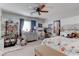 Cozy bedroom with a ceiling fan, large window, and ample shelving for storage and decor at 10422 Prairie Mountain Ave, Las Vegas, NV 89166