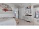 Bright bedroom features a decorative fan, patterned bedding, and ensuite bathroom access at 10422 Prairie Mountain Ave, Las Vegas, NV 89166