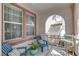 Cozy covered porch with comfortable seating, decorative cushions, and a peaceful atmosphere at 10422 Prairie Mountain Ave, Las Vegas, NV 89166