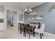Dining area with a dining table and chairs, set against a neutral wall color and tile floors at 10422 Prairie Mountain Ave, Las Vegas, NV 89166