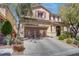 Attractive two-story home with a wide driveway, two-car garage, and professionally landscaped yard at 10422 Prairie Mountain Ave, Las Vegas, NV 89166