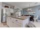 Kitchen island featuring bar stool seating, granite countertops, stainless steel appliances and white cabinets at 10422 Prairie Mountain Ave, Las Vegas, NV 89166