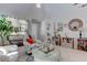 Bright living room with large windows and a decorative armchair at 10422 Prairie Mountain Ave, Las Vegas, NV 89166