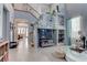 Bright living room featuring high ceilings, staircase, decorative shelving, and tile flooring at 10422 Prairie Mountain Ave, Las Vegas, NV 89166