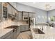This modern kitchen features granite counters, a gas cooktop, stainless appliances, and stylish cabinetry at 10482 Calico Terrace Ave, Las Vegas, NV 89135