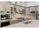 Gourmet kitchen with built-in stainless appliances, granite counters, and stylish backsplash at 10482 Calico Terrace Ave, Las Vegas, NV 89135