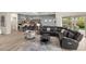 Open-concept living space with a modern kitchen, comfortable seating, and seamless flow for entertaining guests at 10482 Calico Terrace Ave, Las Vegas, NV 89135