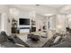 Elegant living room with a fireplace, custom shelving, and ample seating, providing a cozy and sophisticated ambiance at 10482 Calico Terrace Ave, Las Vegas, NV 89135