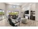 Stylish living room with a modern fireplace, large windows, and comfortable seating, perfect for relaxation at 10482 Calico Terrace Ave, Las Vegas, NV 89135