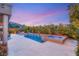 An inviting pool and spa combination with a fire pit and well-manicured landscaping, perfect for outdoor living at 10482 Calico Terrace Ave, Las Vegas, NV 89135