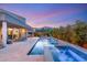 Resort-style backyard featuring a pool, spa, water features, and a cozy fire pit with mountain views at 10482 Calico Terrace Ave, Las Vegas, NV 89135