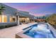 Luxurious outdoor space featuring a pool, jacuzzi, patio furniture, and mountain views at 10482 Calico Terrace Ave, Las Vegas, NV 89135