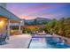 Backyard pool with a fire pit, seating area and covered dining area, creating an inviting outdoor space at 10482 Calico Terrace Ave, Las Vegas, NV 89135