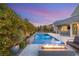 Backyard pool with a modern fire pit, patio area and lush landscaping creates an ideal outdoor oasis at 10482 Calico Terrace Ave, Las Vegas, NV 89135