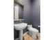 Powder room features a pedestal sink, designer wallpaper, and modern toilet at 10482 Calico Terrace Ave, Las Vegas, NV 89135