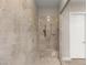 Shower with tiled walls, a shower bench, and modern fixtures at 10482 Calico Terrace Ave, Las Vegas, NV 89135