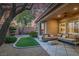 A cozy backyard featuring a patio, artificial turf, and lush landscaping at 11763 Kingsland Ave, Las Vegas, NV 89138