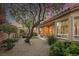 The backyard has beautiful landscaping with a seating area and large tree at 11763 Kingsland Ave, Las Vegas, NV 89138