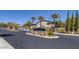 The 'Talaverde' community entrance is adorned with lush desert landscaping and well manicured greenery at 11763 Kingsland Ave, Las Vegas, NV 89138