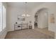 Dining room with modern chandelier, console table, and arched doorway leading to other living spaces at 11763 Kingsland Ave, Las Vegas, NV 89138