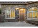 Inviting front entrance with stone accents, arched window and doorway, and a neutral-colored front door at 11763 Kingsland Ave, Las Vegas, NV 89138