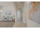 Hallway featuring neutral walls, arched doorways, tiled flooring, and artwork at 11763 Kingsland Ave, Las Vegas, NV 89138
