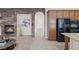 A modern kitchen boasting tile floors, stainless steel appliances, and granite countertops next to an inviting living room at 11763 Kingsland Ave, Las Vegas, NV 89138