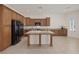 Spacious kitchen with ample cabinet space, tile floors, and a large center island perfect for entertaining at 11763 Kingsland Ave, Las Vegas, NV 89138