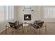 Neutral-toned living room featuring a fireplace, arched doorways, modern furniture, and bright natural light at 11763 Kingsland Ave, Las Vegas, NV 89138