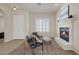 Neutral-toned living room featuring a fireplace, arched doorways, modern furniture, and bright natural light at 11763 Kingsland Ave, Las Vegas, NV 89138