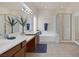 Bright bathroom with double sinks, soaking tub, vanity area, and framed glass shower at 11763 Kingsland Ave, Las Vegas, NV 89138