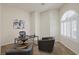 Bright home office with arched window, plantation shutters, modern desk, and comfortable seating area at 11763 Kingsland Ave, Las Vegas, NV 89138
