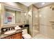 Elegant bathroom with a glass-enclosed shower and a vanity with a large mirror at 125 E Harmon Ave # 1620, Las Vegas, NV 89109