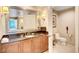 Bathroom featuring granite counters, wood cabinets and separate toilet room at 125 E Harmon Ave # 1620, Las Vegas, NV 89109